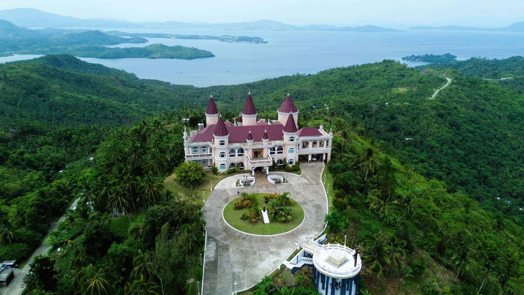 The Island Castle on a forested hilltop in San Jose, with the surrounding islands and sea behind it
