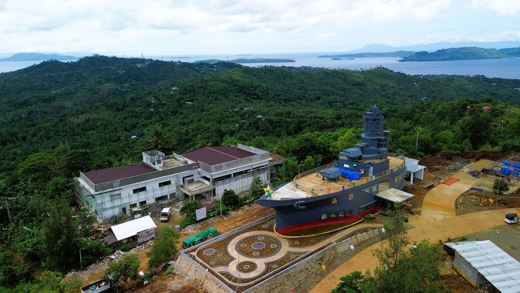 The ship-shaped Provincial Capitol building on a ridge, with the archipelago visible beyond